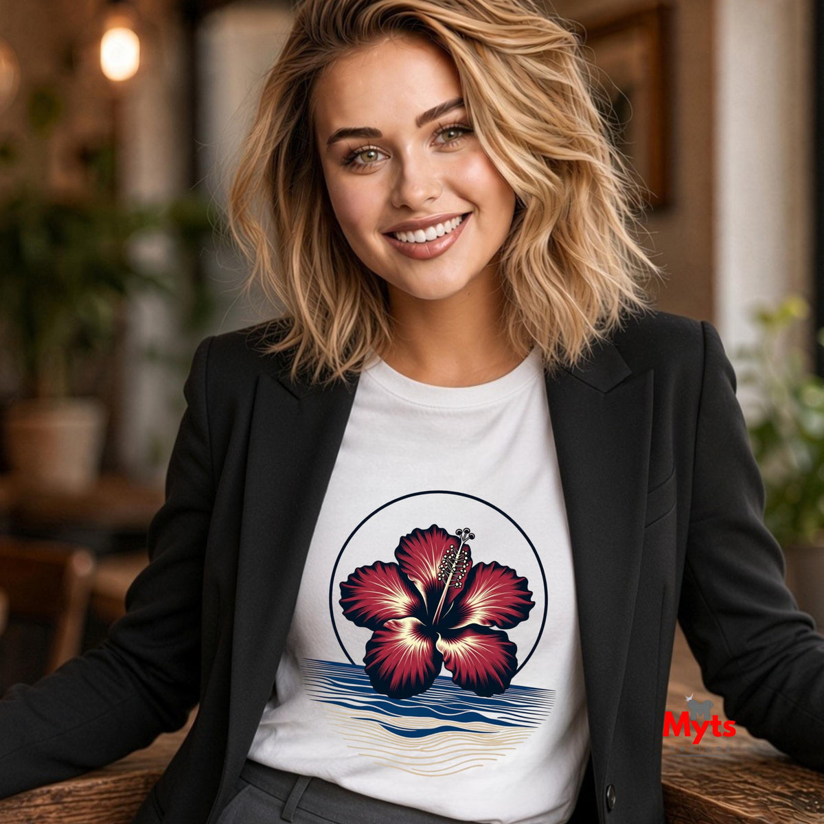 A sophisticated woman wearing a White tropical hibiscus flower graphic T-shirt featuring a vibrant red bloom, navy circular outline, and stylised blue and sandy-gold ocean waves.