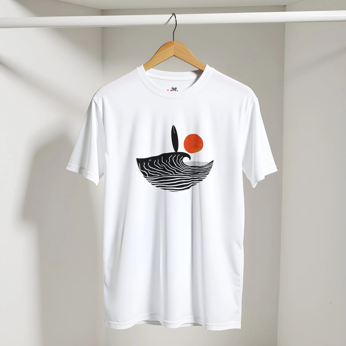 White t-shirt with a black and red design on a hanger against a white wall