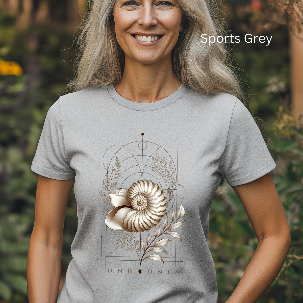 “Woman wearing a Sports Grey Unbound Nautilus shell graphic T-shirt outdoors.”