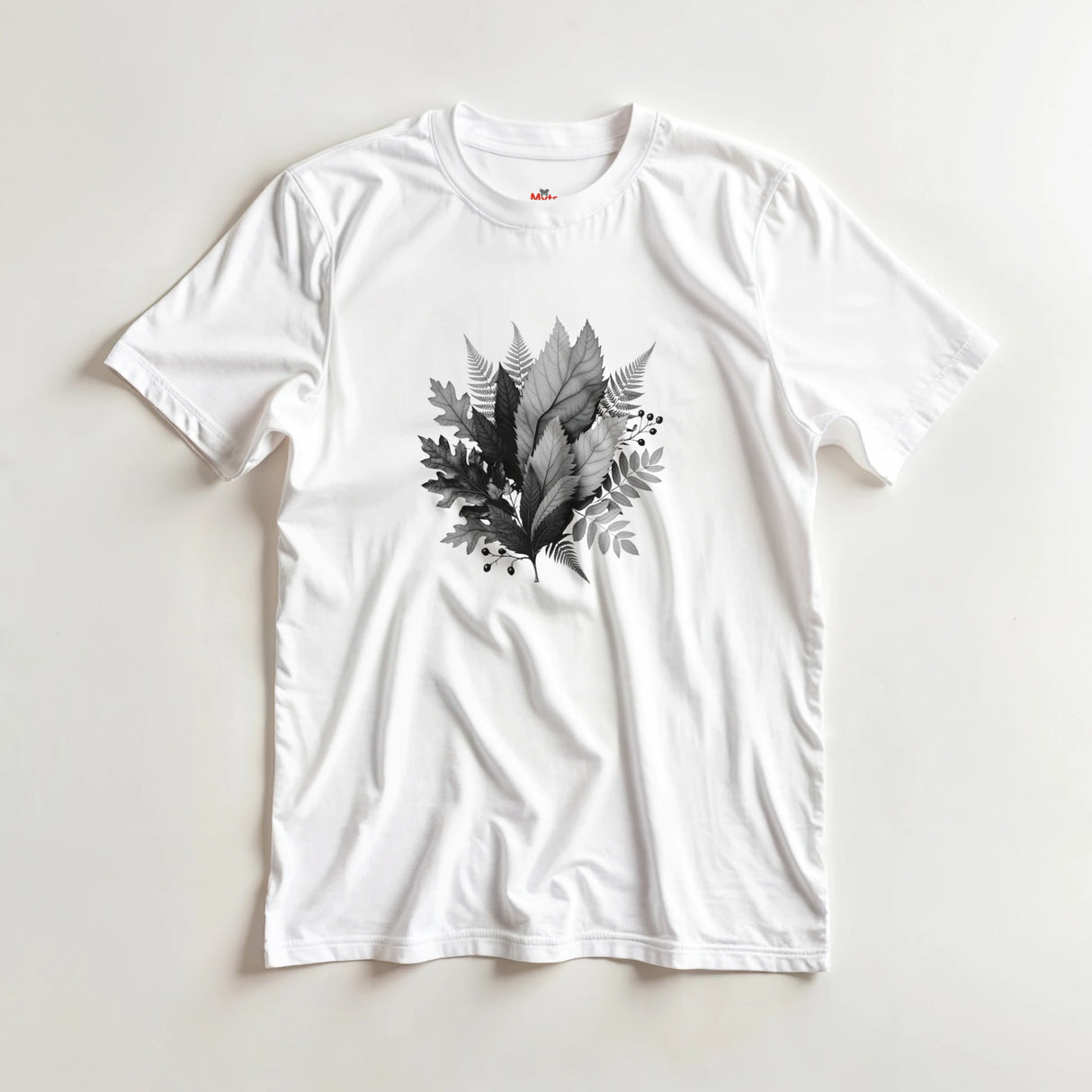 White t-shirt with black leaf design on a light gray background