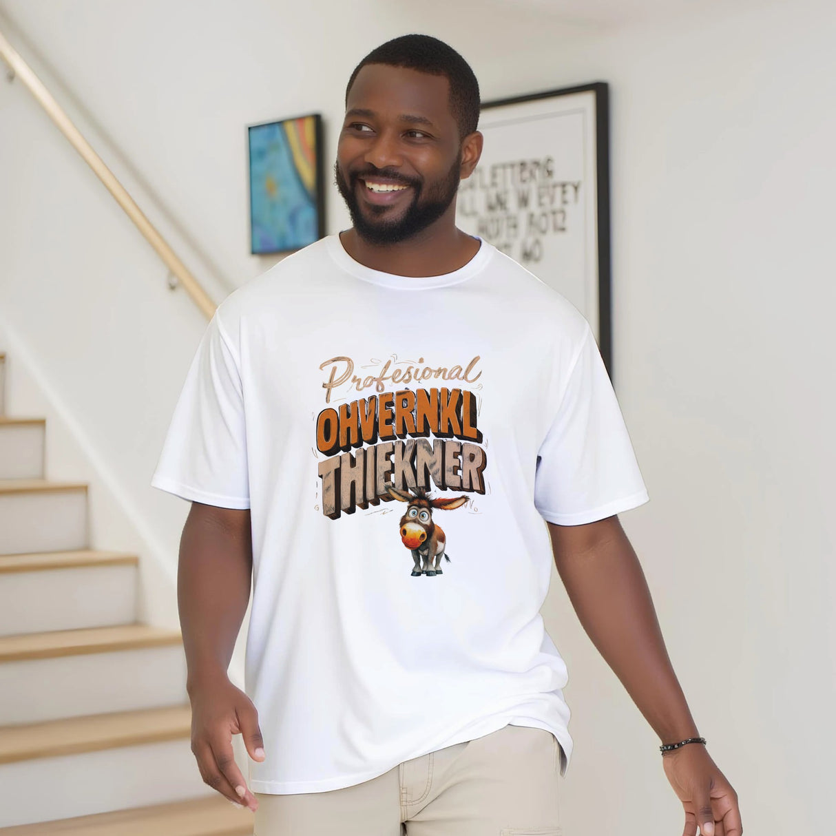 Man wearing a white t-shirt with a graphic design and text, standing indoors.