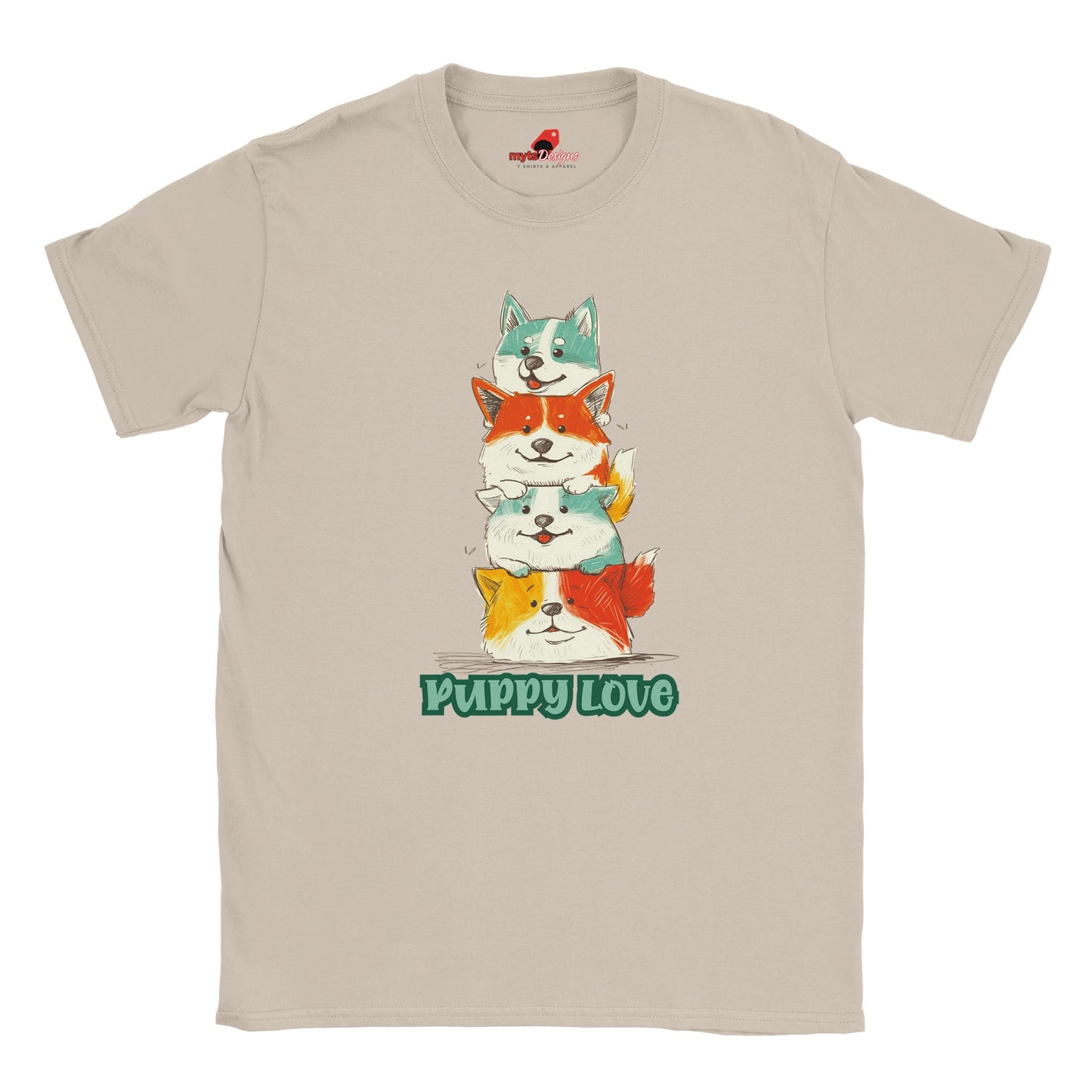 A flat lay sand T-shirt featuring a colorful graphic of four stacked cartoon puppies in teal, orange, cream, and yellow shades with the words “Puppy Love” in playful green text below