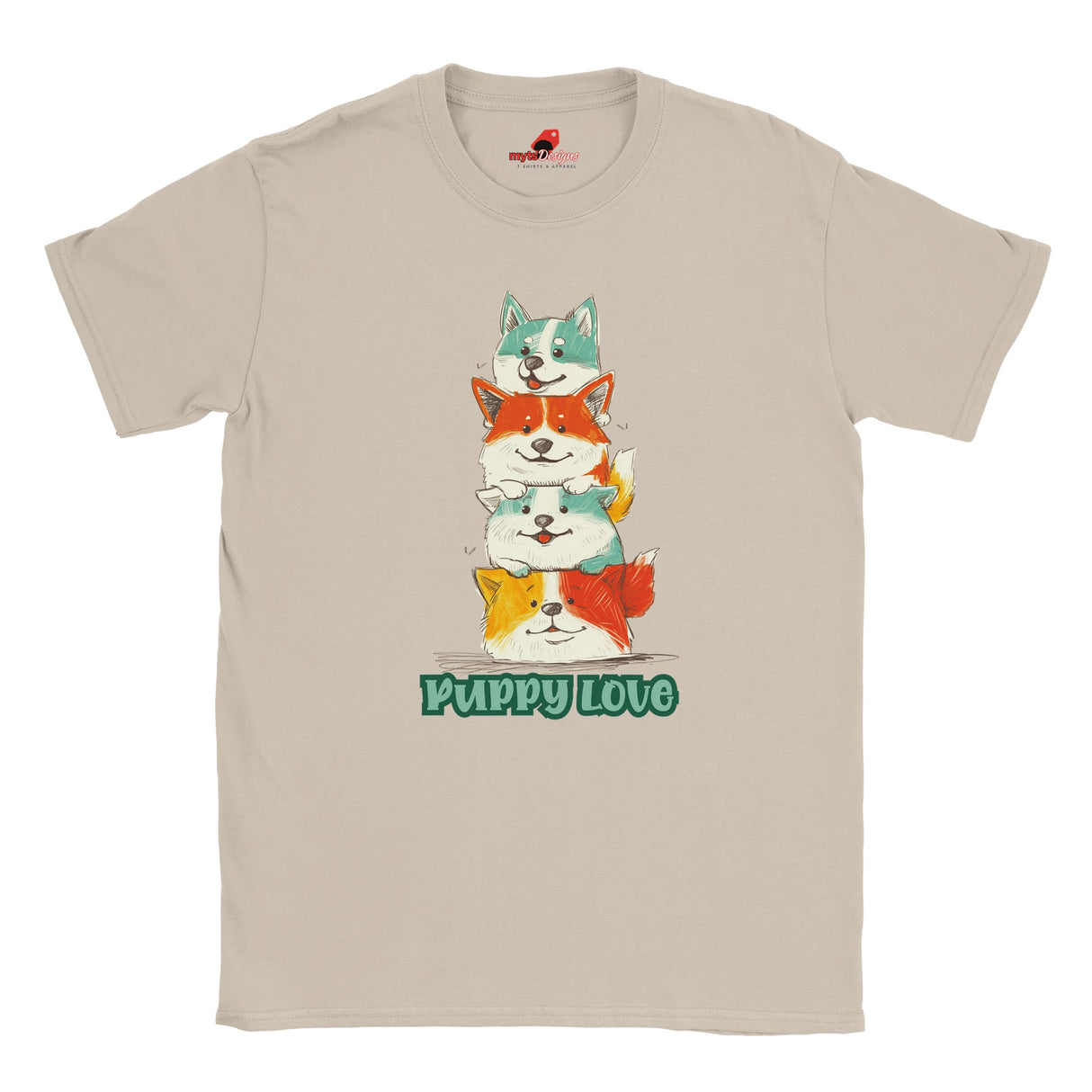 A flat lay sand T-shirt featuring a colorful graphic of four stacked cartoon puppies in teal, orange, cream, and yellow shades with the words “Puppy Love” in playful green text below