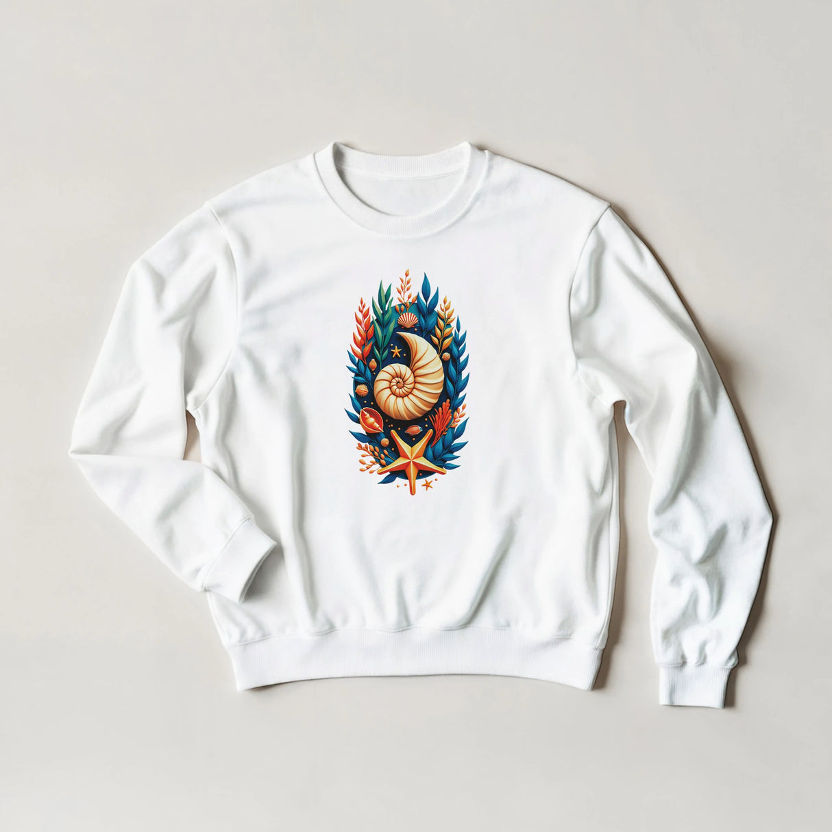 A white crewneck sweatshirt with a colorful nautical graphic on the chest, featuring a nautilus shell, blue leaves, and an orange starfish, laid flat on a light beige background.