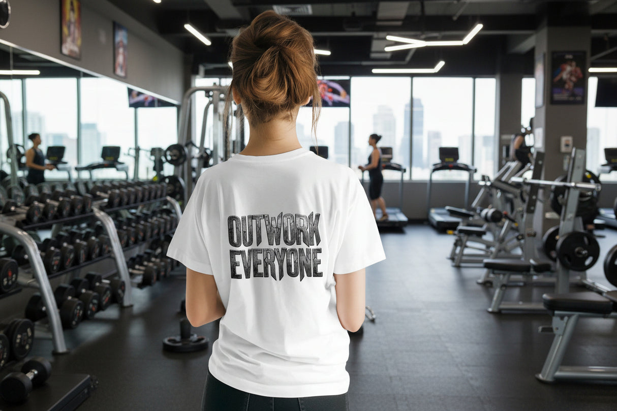 Person wearing a white t-shirt with 'OUTWORK EVERYONE' text on the back, standing against a white background