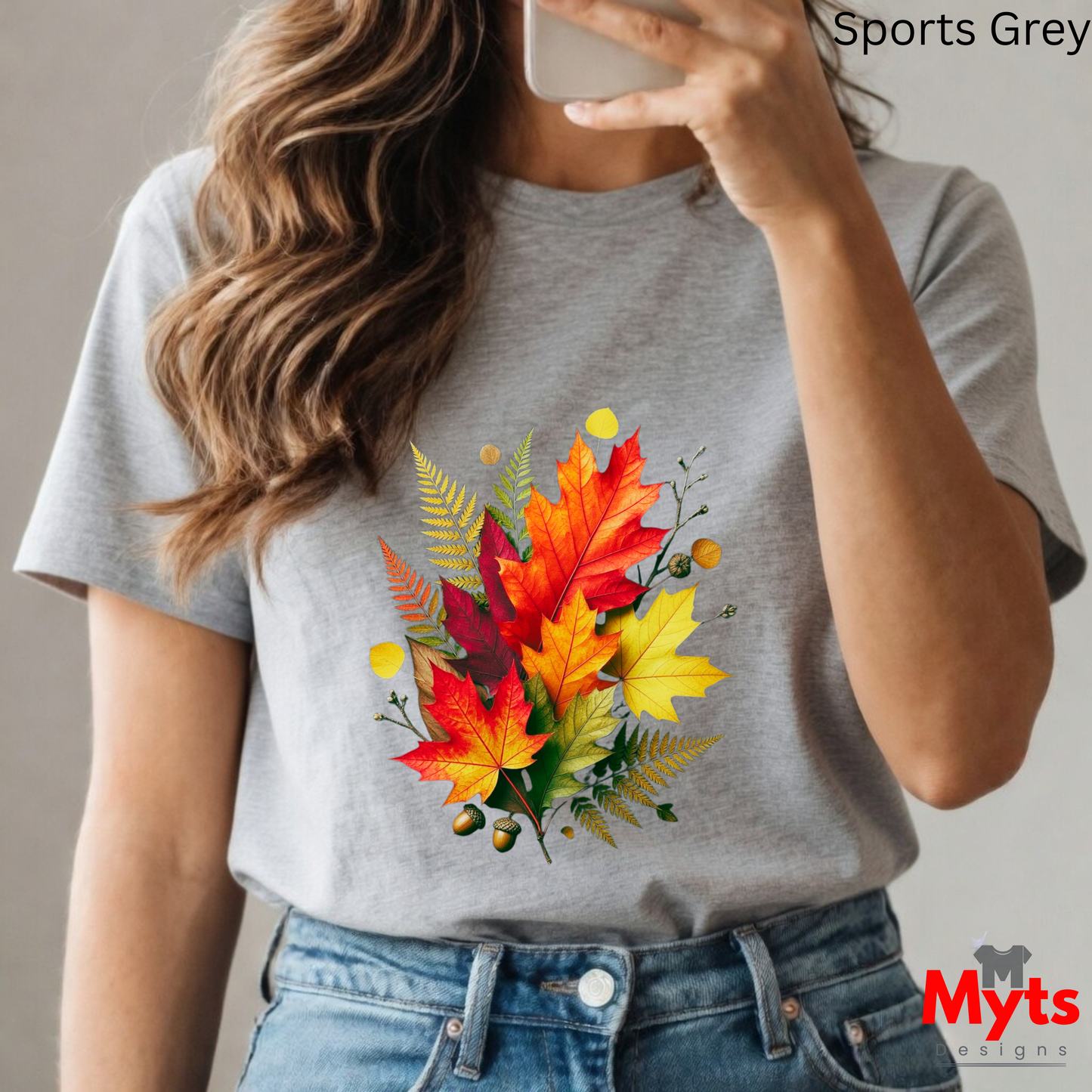 Person wearing a gray t-shirt with a colorful leaf design, taking a selfie.