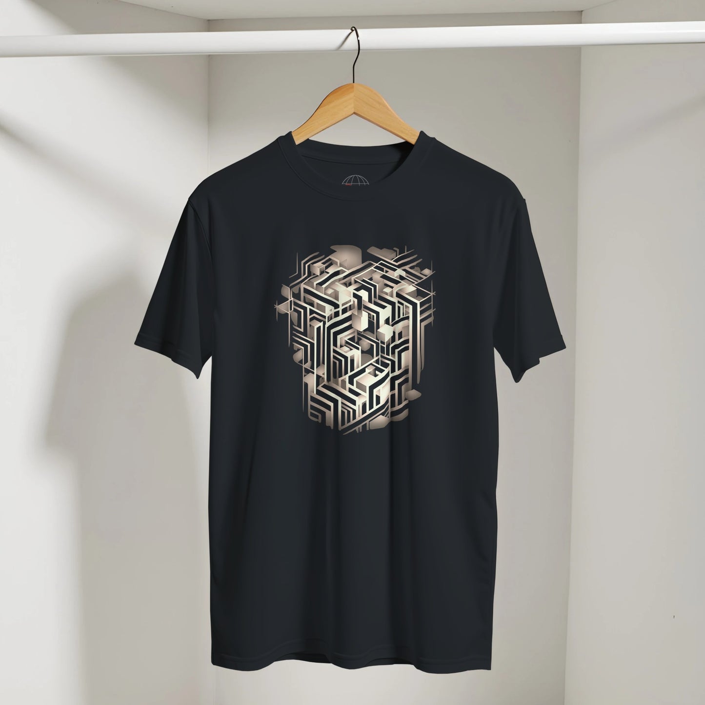 Black t-shirt with geometric design on a hanger against a neutral background