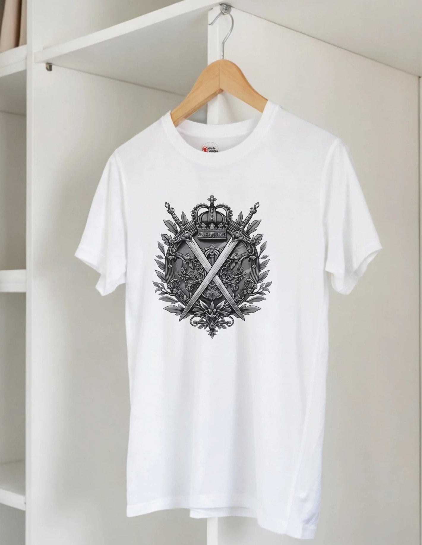 White t-shirt with black graphic design on a hanger against a white wall.