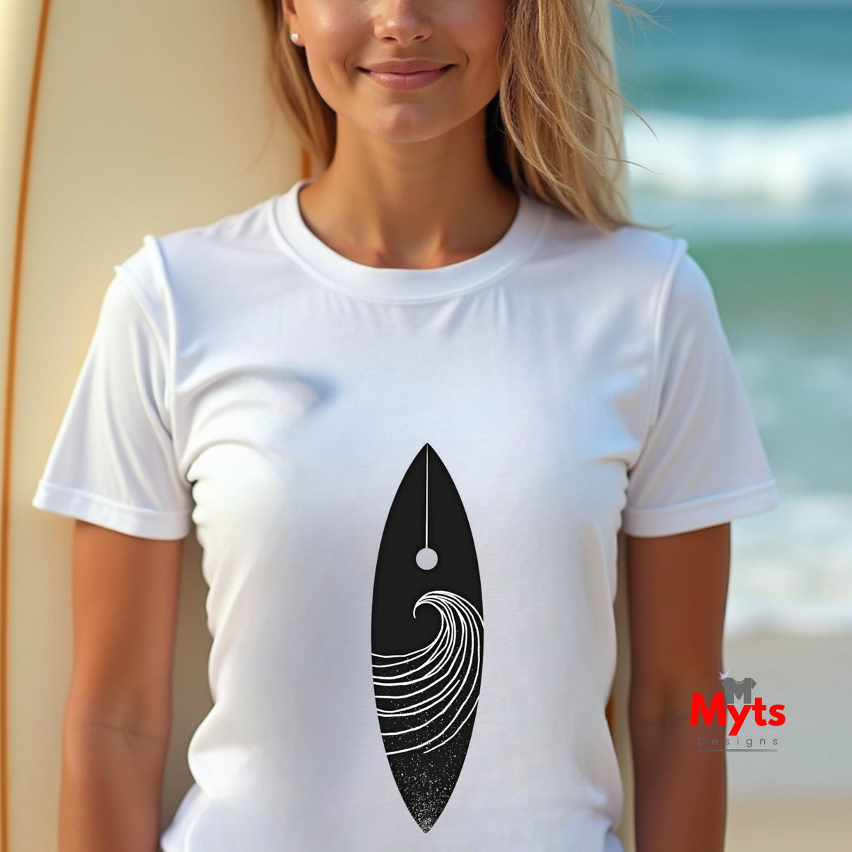 Woman wearing a white t-shirt with a black and white design, standing by a beach.