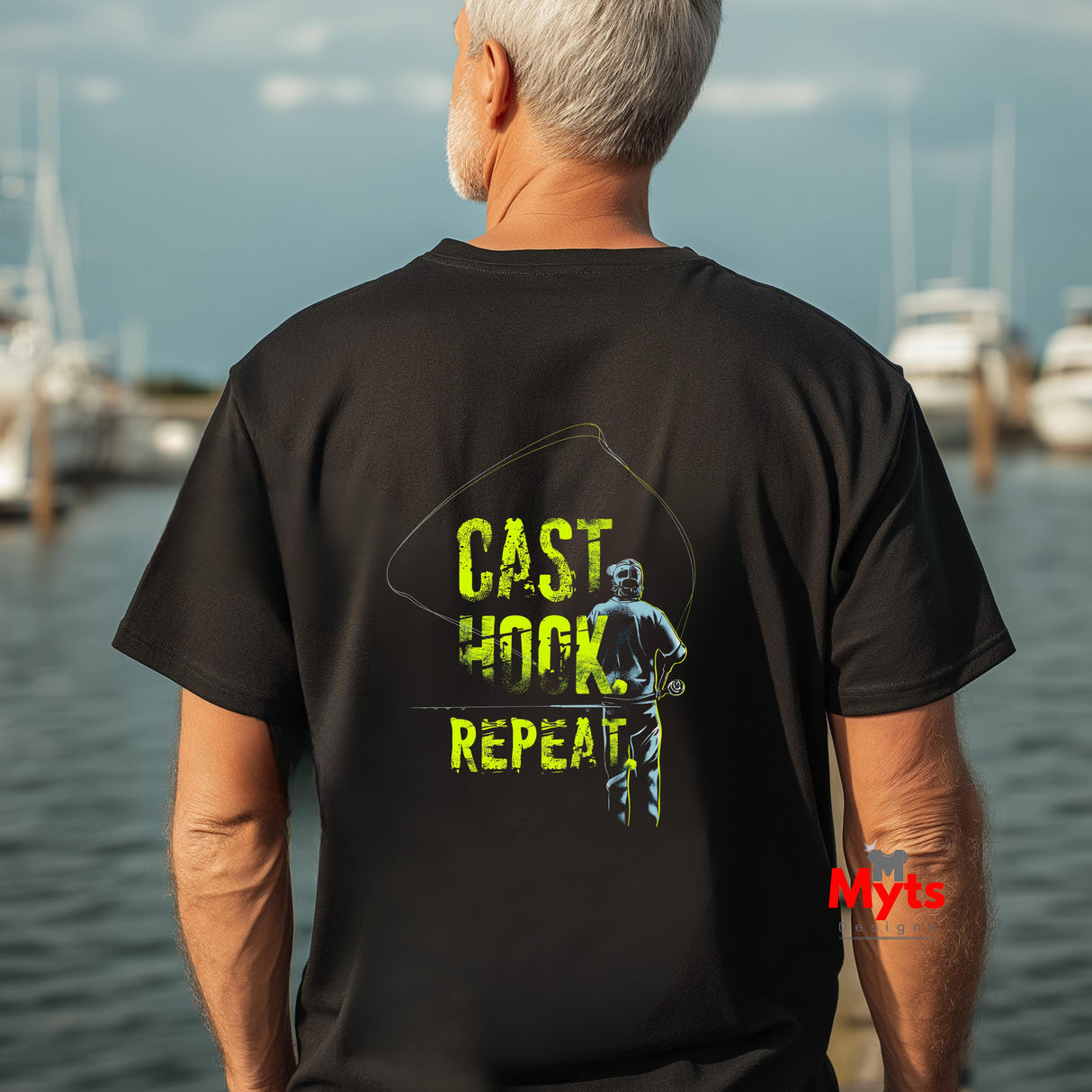Man wearing a black t-shirt with 'CAST HOOK REPEAT' text and graphic, standing by water.