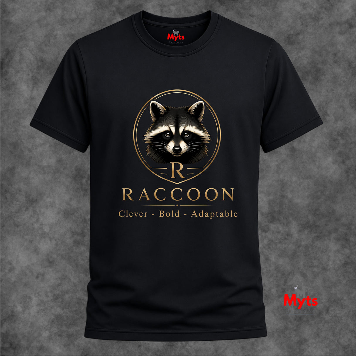 A black short-sleeve crewneck t-shirt featuring a gold and white raccoon graphic with the word 'RACCOON' and the phrase 'Clever - Bold - Adaptable' printed on the front, displayed against a textured gray background.