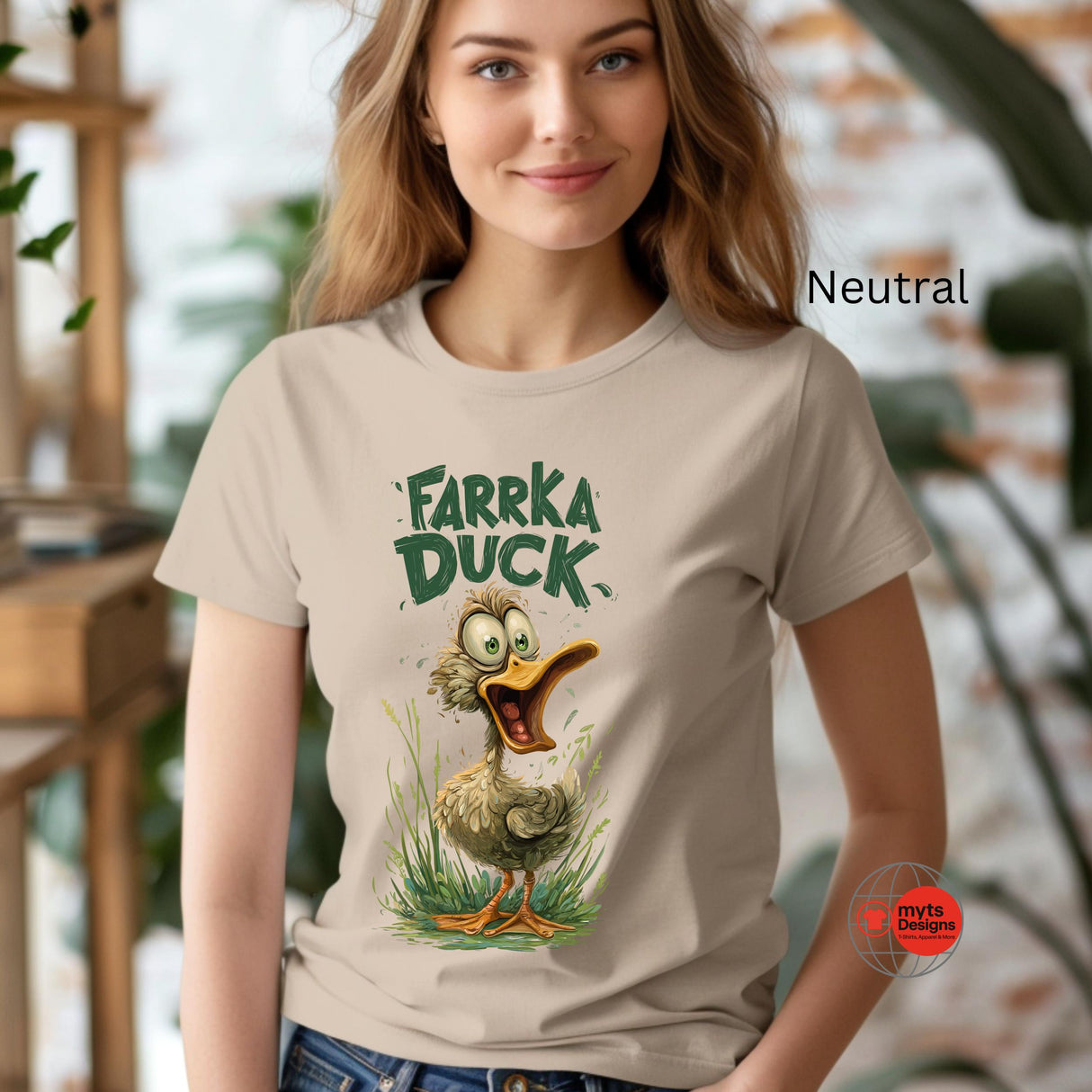 Woman wearing a t-shirt with 'Farka Duck' graphic design in an indoor setting.