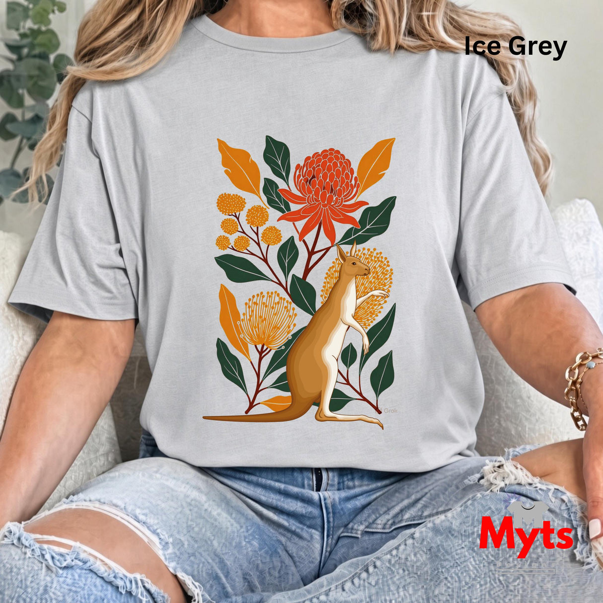 A woman wearing an oversized Ice grey t-shirt with a colorful graphic of a kangaroo surrounded by orange and yellow flowers and green leaves. The text 'Ice Grey' is visible in the top right corner, and 'Myts' is written in red in the bottom right corner.