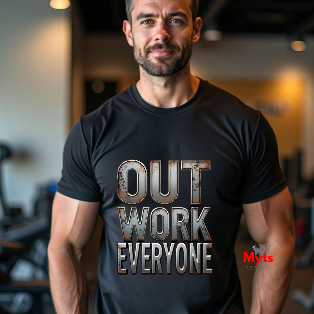 Man wearing a black t-shirt with 'OUT WORK EVERYONE' text in a gym setting