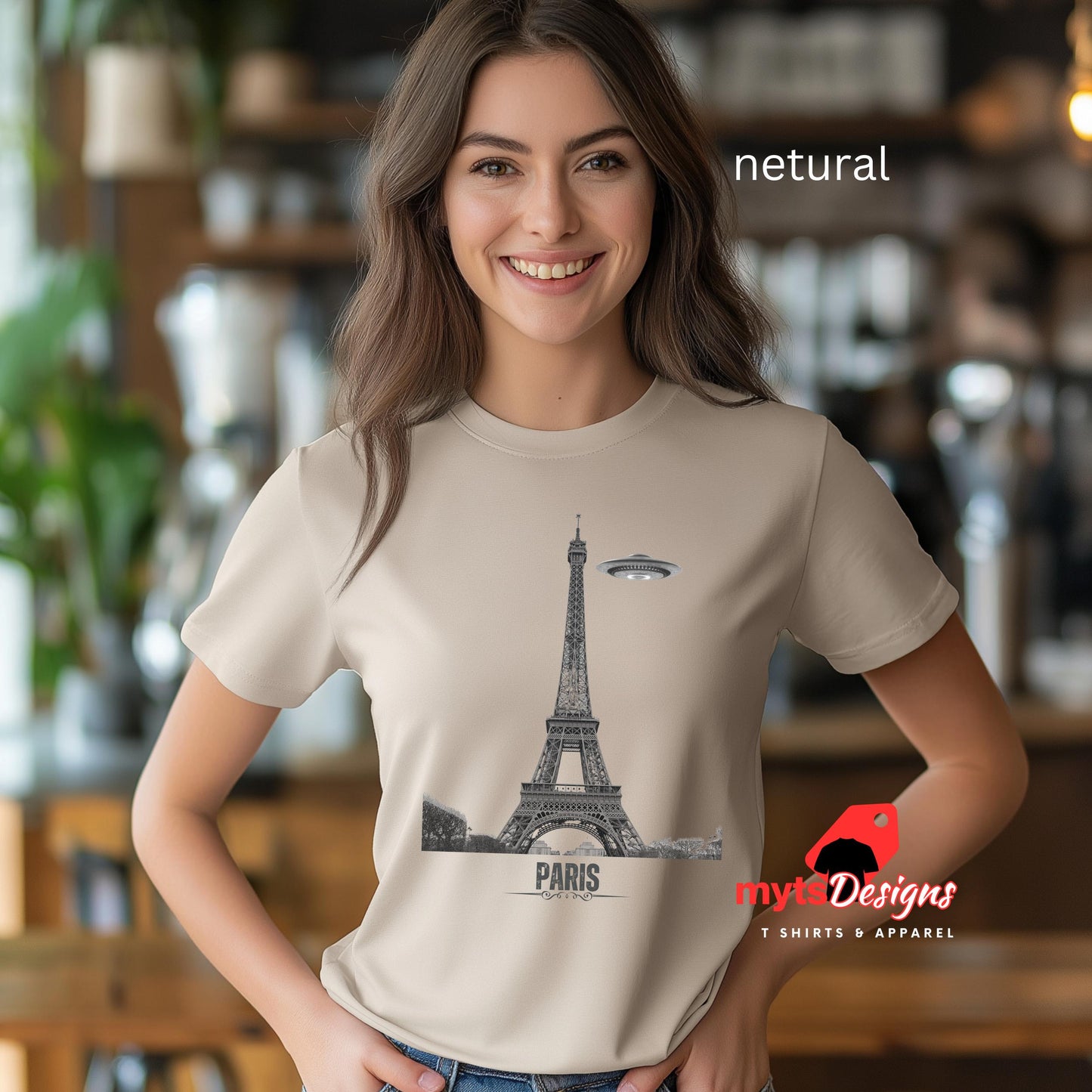 Front view of a Netural soft casual tee featuring a whimsical graphic of the Eiffel Tower with a retro‑style spaceship orbiting it, printed on ultra‑soft Gildan 64000 cotton.