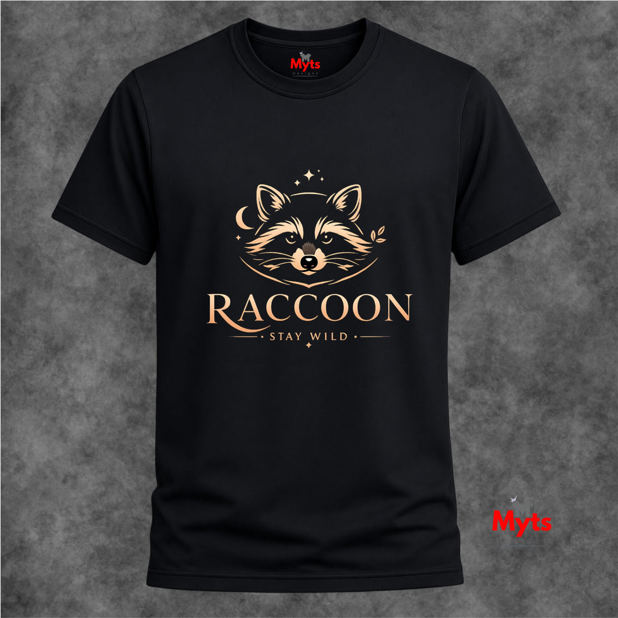 A black short-sleeve crewneck t-shirt with a gold graphic of a raccoon's face and the text 'RACCOON STAY WILD' on the front, displayed against a textured gray background.