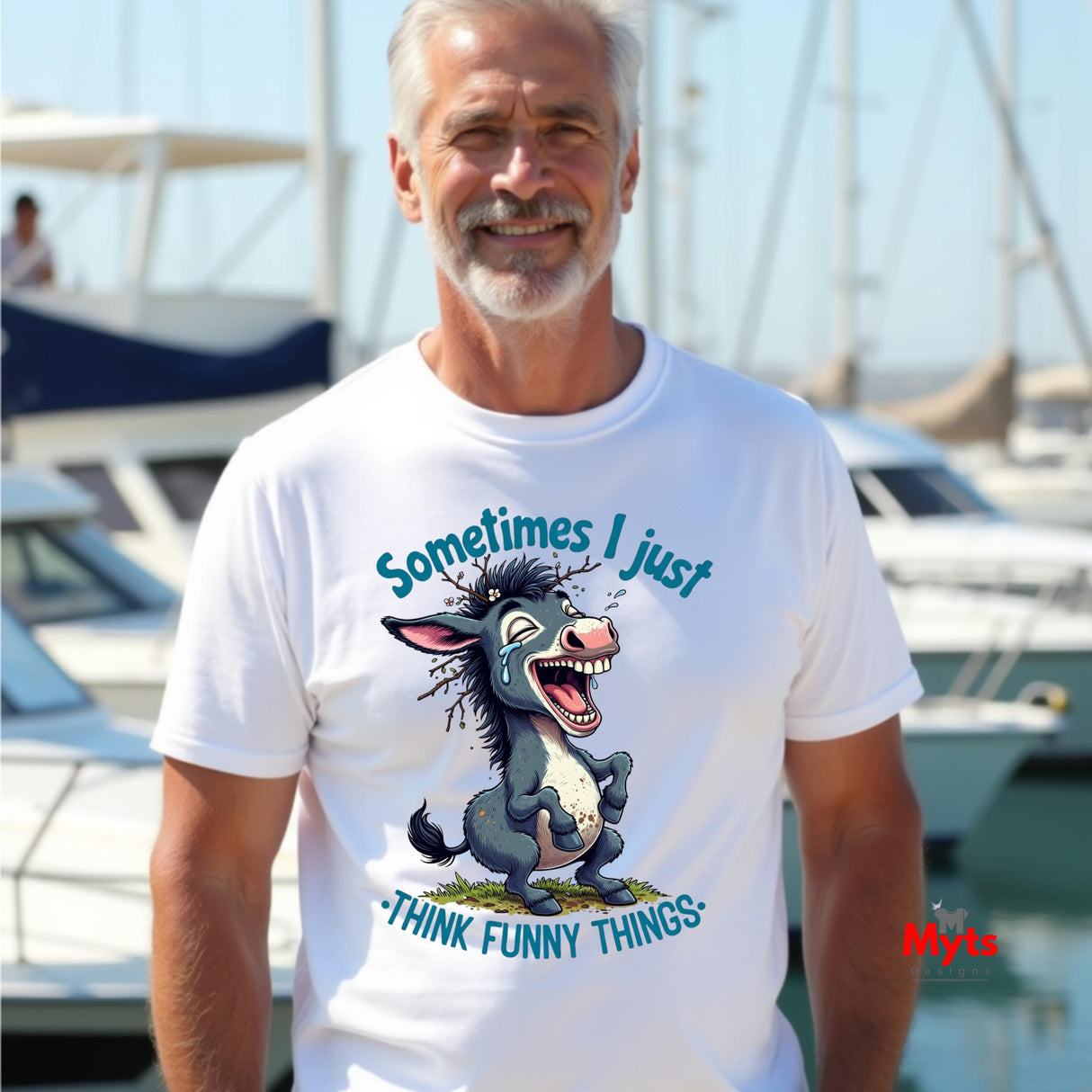 Man wearing a white t-shirt with a cartoon donkey graphic and text at a marina.