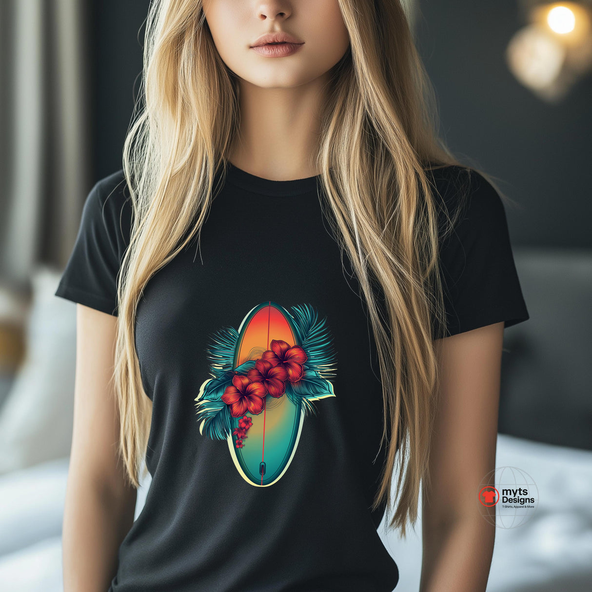 A black T-shirt featuring a vibrant graphic of a surfboard in sunset hues surrounded by red hibiscus flowers and green palm leaves.