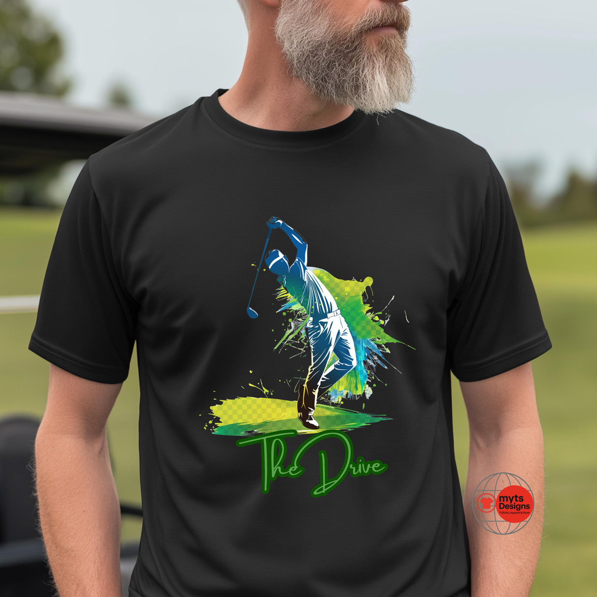 Man wearing a black t-shirt with a colorful graphic design on a golf course.