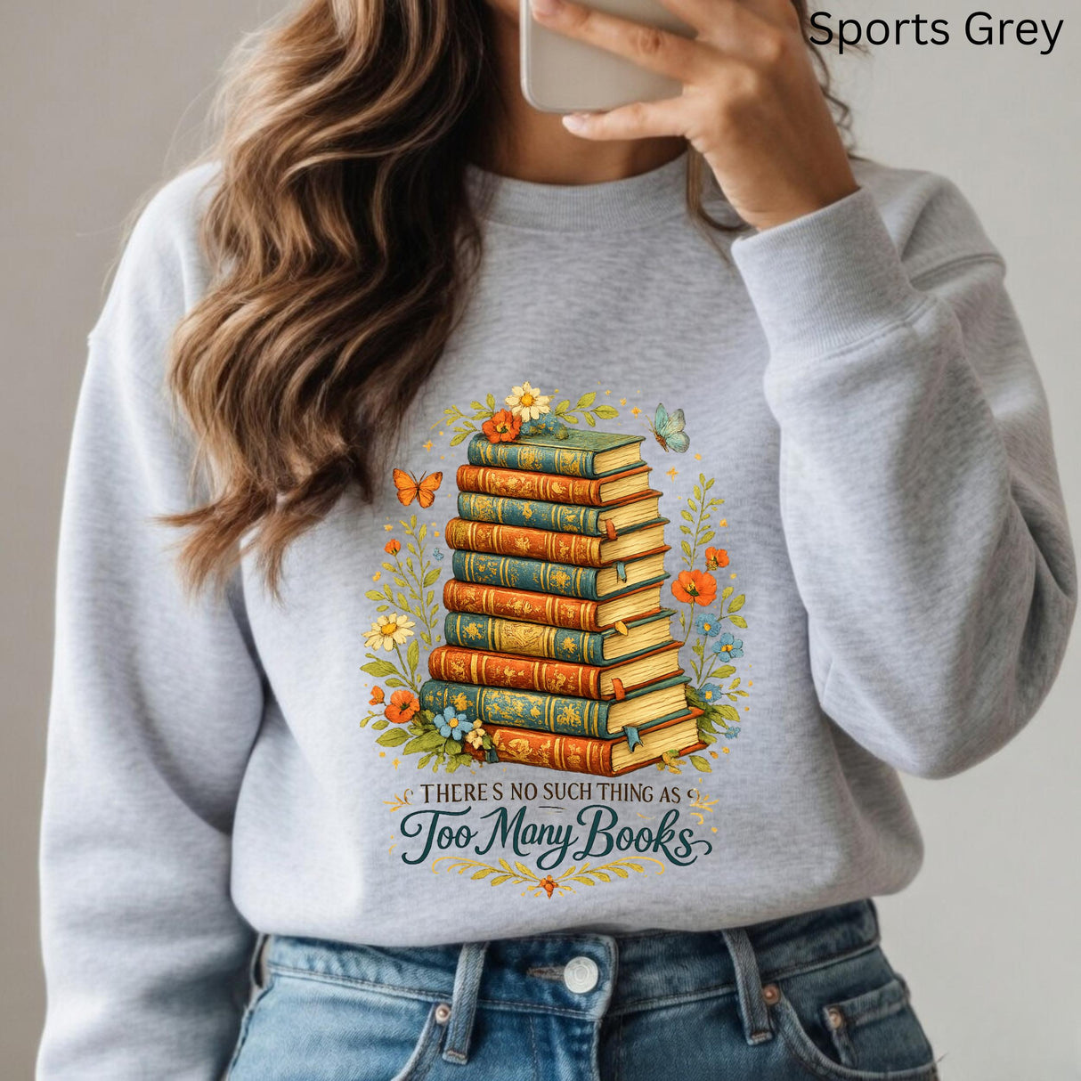 Person wearing a gray sweatshirt with a book-themed design and text.