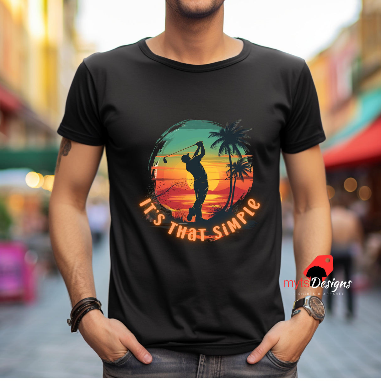 Person wearing a black t-shirt with a colorful graphic and text, standing in an urban setting.