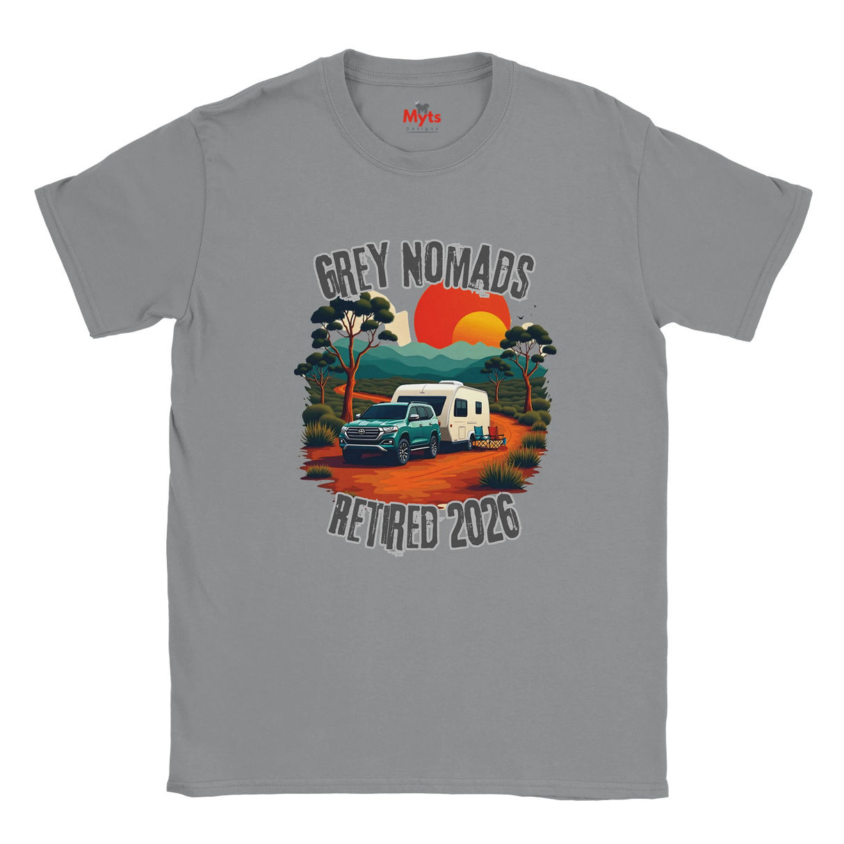 A gray short-sleeve crewneck t-shirt featuring a retro-style graphic of a green pickup truck towing a white camper on an orange dirt road, with a sunset and the text 'GREY NOMADS RETIRED 2026'. The brand 'MyTb' is visible on the inner neck label.