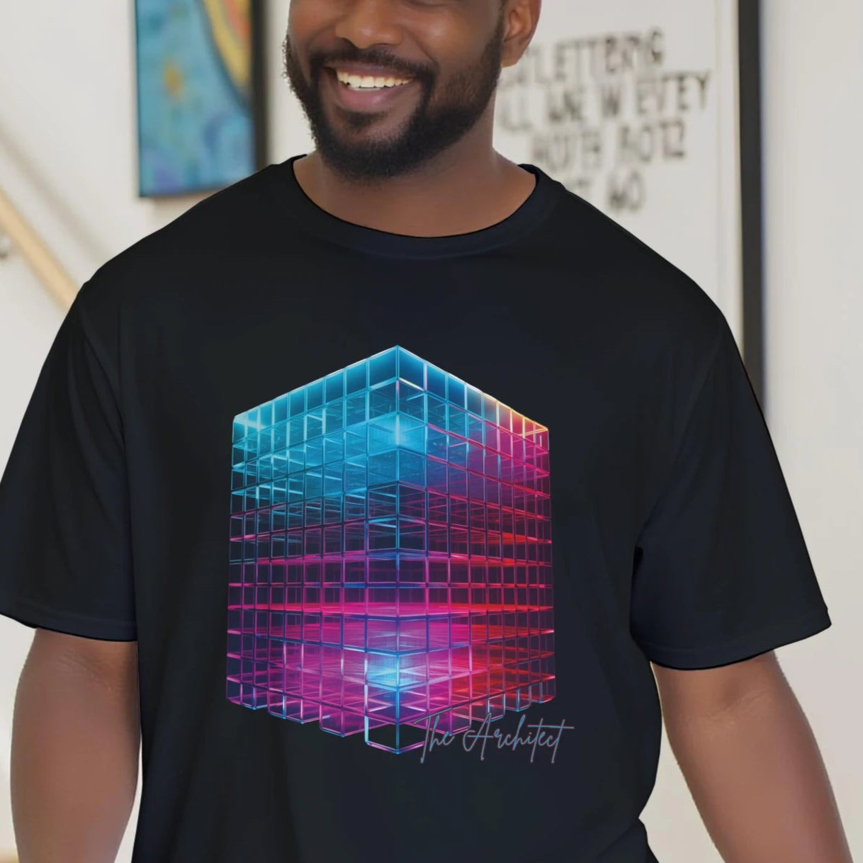 Man wearing a black t-shirt with a colorful geometric design, standing in a home setting.