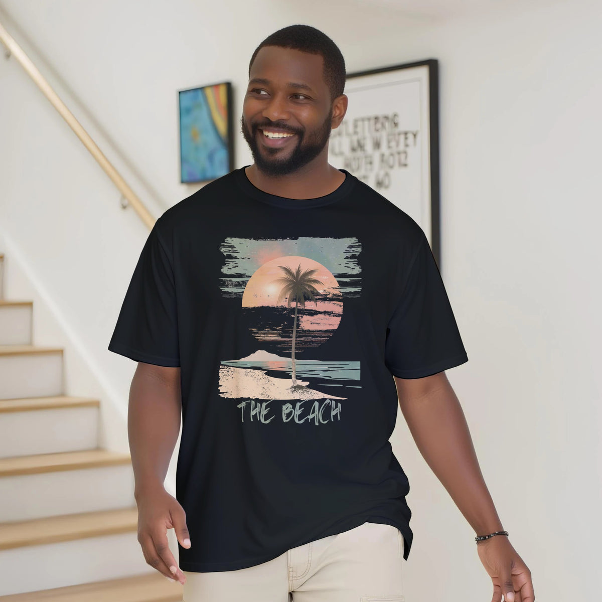 A man wearing the black "The Beach" T-shirt