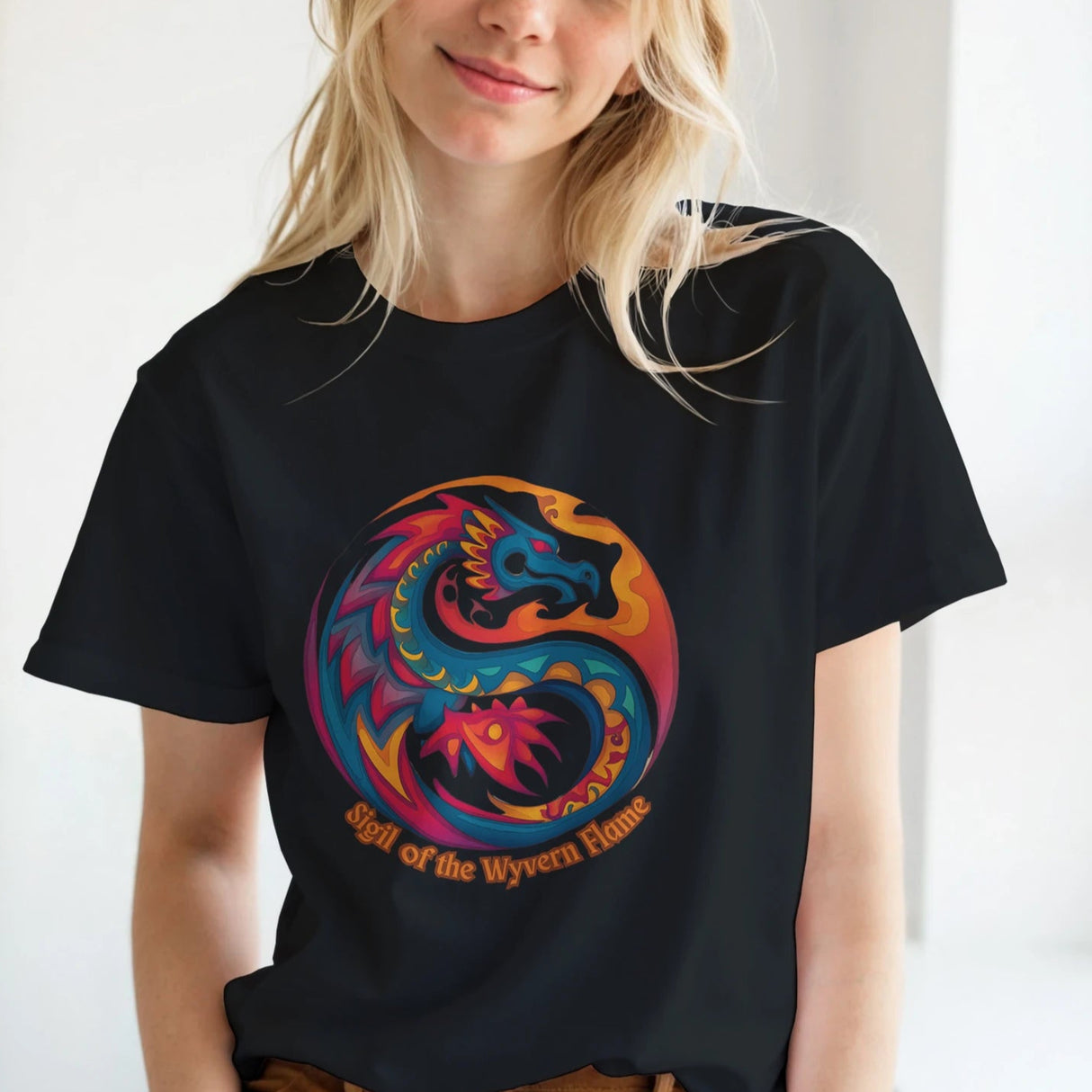 Front view of a woman wearing a black T‑shirt featuring a bold dragon symbol graphic centered on a soft cotton tee