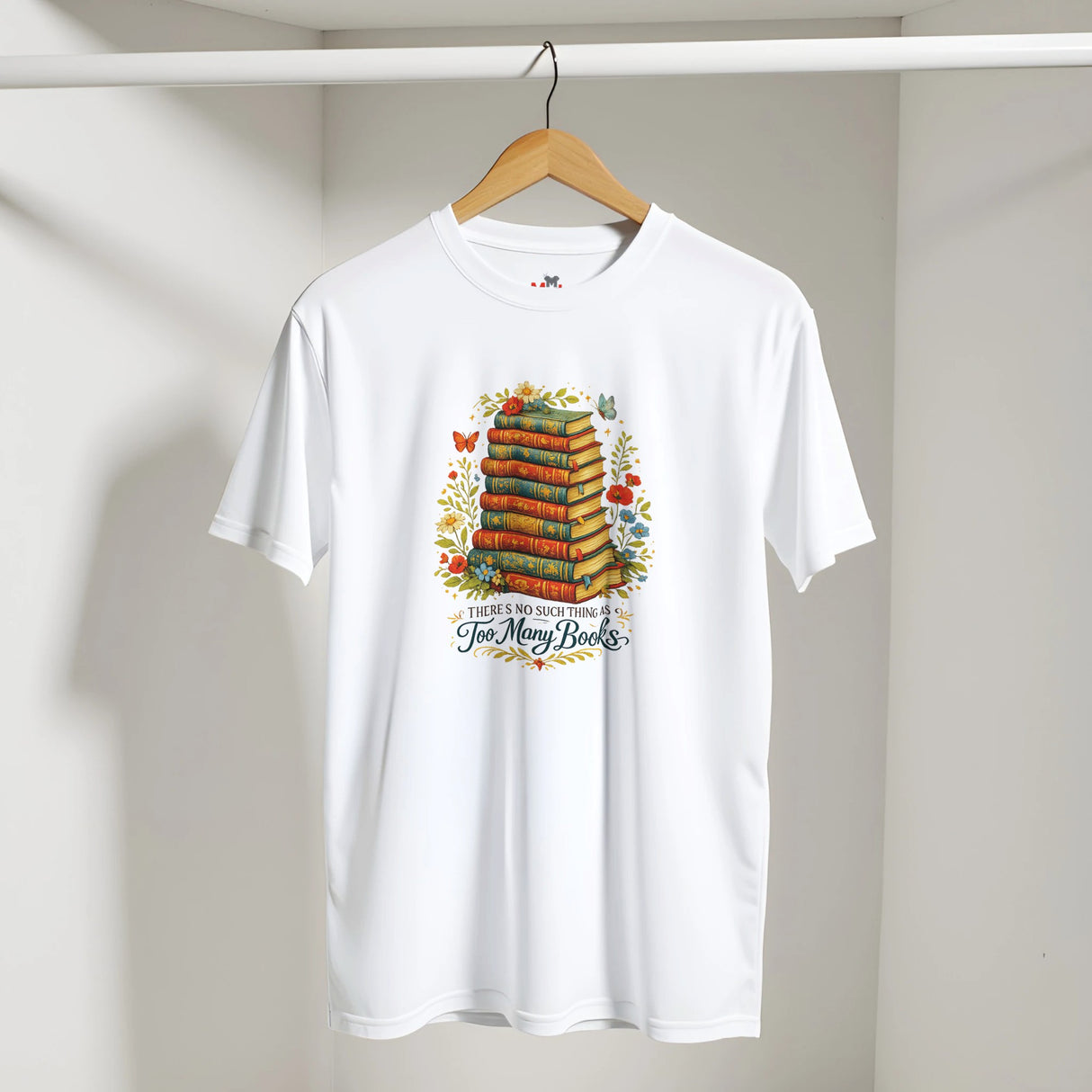 White t-shirt with book-themed design on a hanger against a plain background