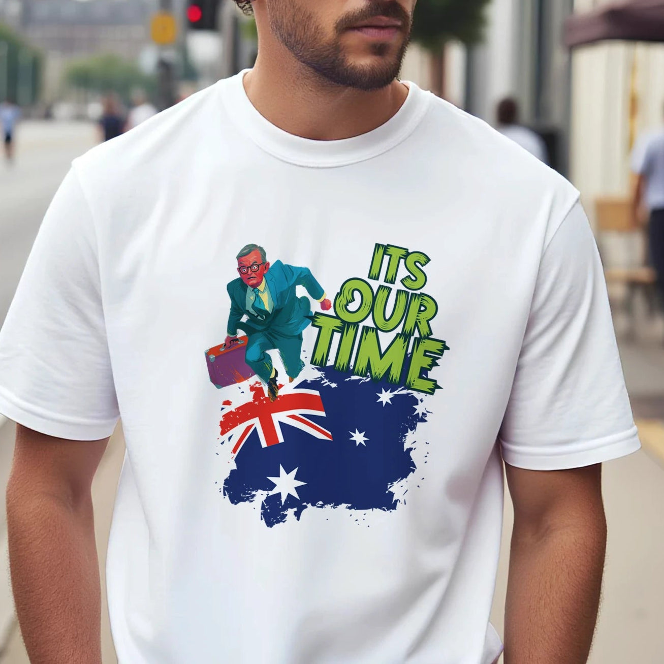 A man wearing a white t-shirt with a graphic design on a city street
