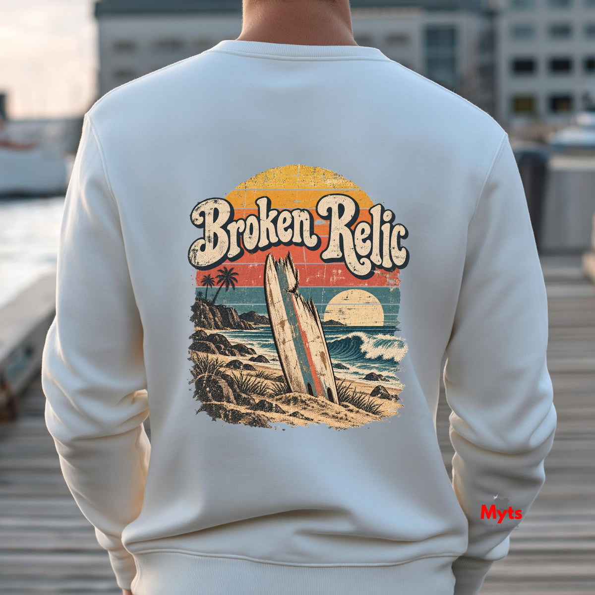 Broken Relic white unisex crewneck sweatshirt with small front surf graphic and large vintage surfboard beach design on back