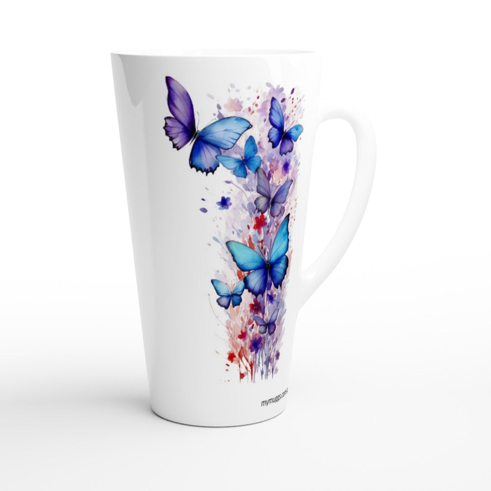 A tall white ceramic latte mug featuring a vibrant watercolor-style print of blue and purple butterflies with red and purple paint splatters, shown on a clean white background.