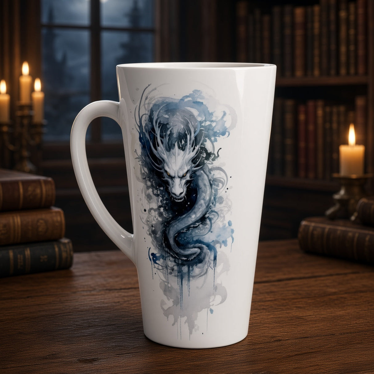 A tall white ceramic mug with a blue and gray watercolor dragon design, set on a wooden table in a dimly lit library with candles and bookshelves in the background.
