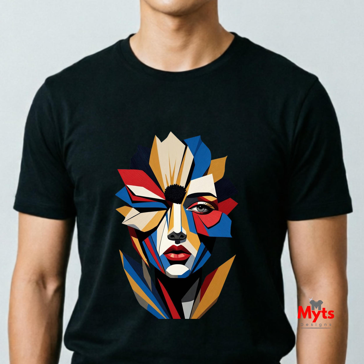 Man wearing a black abstract geometric face T-shirt featuring a colourful fragmented portrait design in red, blue, gold, cream and black.