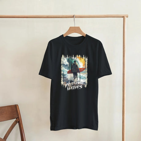 Black t-shirt with a graphic design of a person with a surfboard and 'Plashing Waves' text, hanging on a wooden rack.