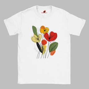 White t-shirt featuring minimalist floral line art with abstract red, yellow, and orange flowers and green leaves, laid flat on a wooden surface with rolled sleeves.