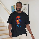 Man wearing a black t-shirt with a colorful graphic design, standing in a home setting.