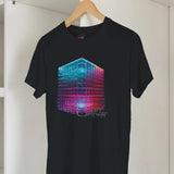 Black t-shirt with a colorful geometric design on a hanger against a white wall.
