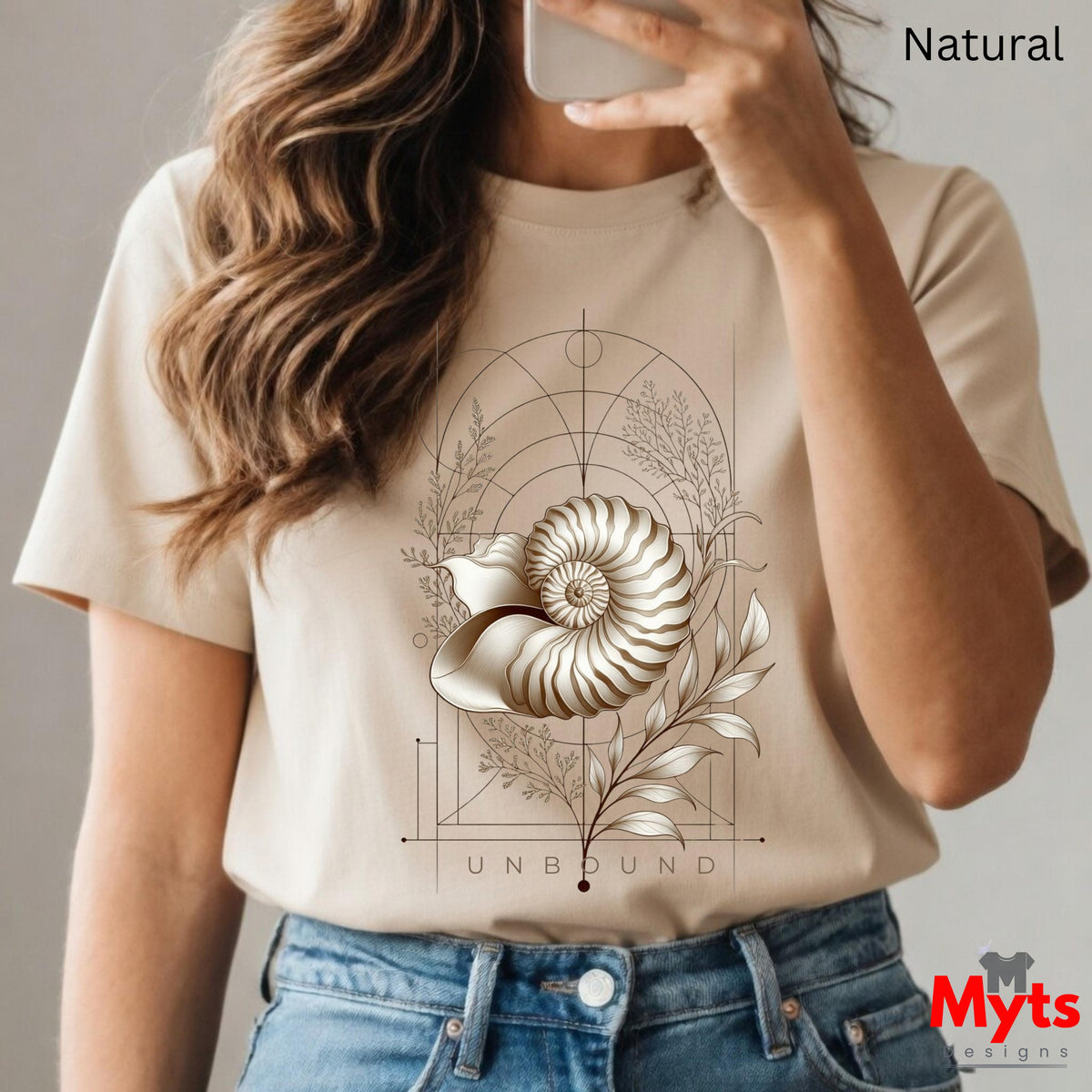  “Woman wearing a natural Unbound Nautilus shell graphic T-shirt outdoors.”