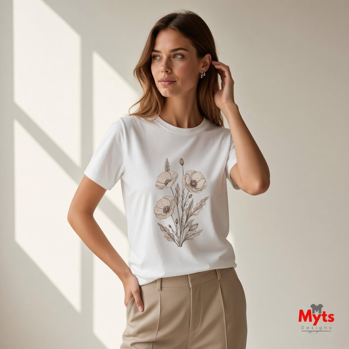 Woman wearing a white minimalist poppy flower T-shirt featuring delicate neutral botanical floral line art by MytsDesigns.