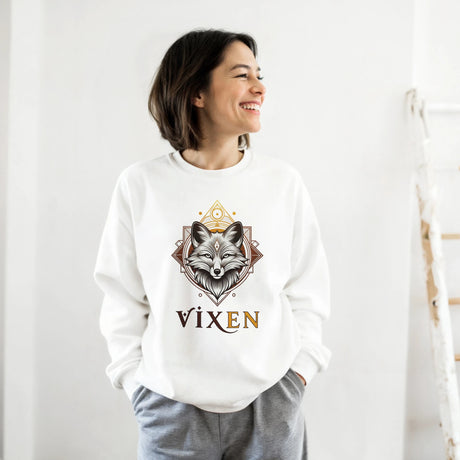 Person wearing a white sweatshirt with a fox design and 'Vixen' text on a plain background