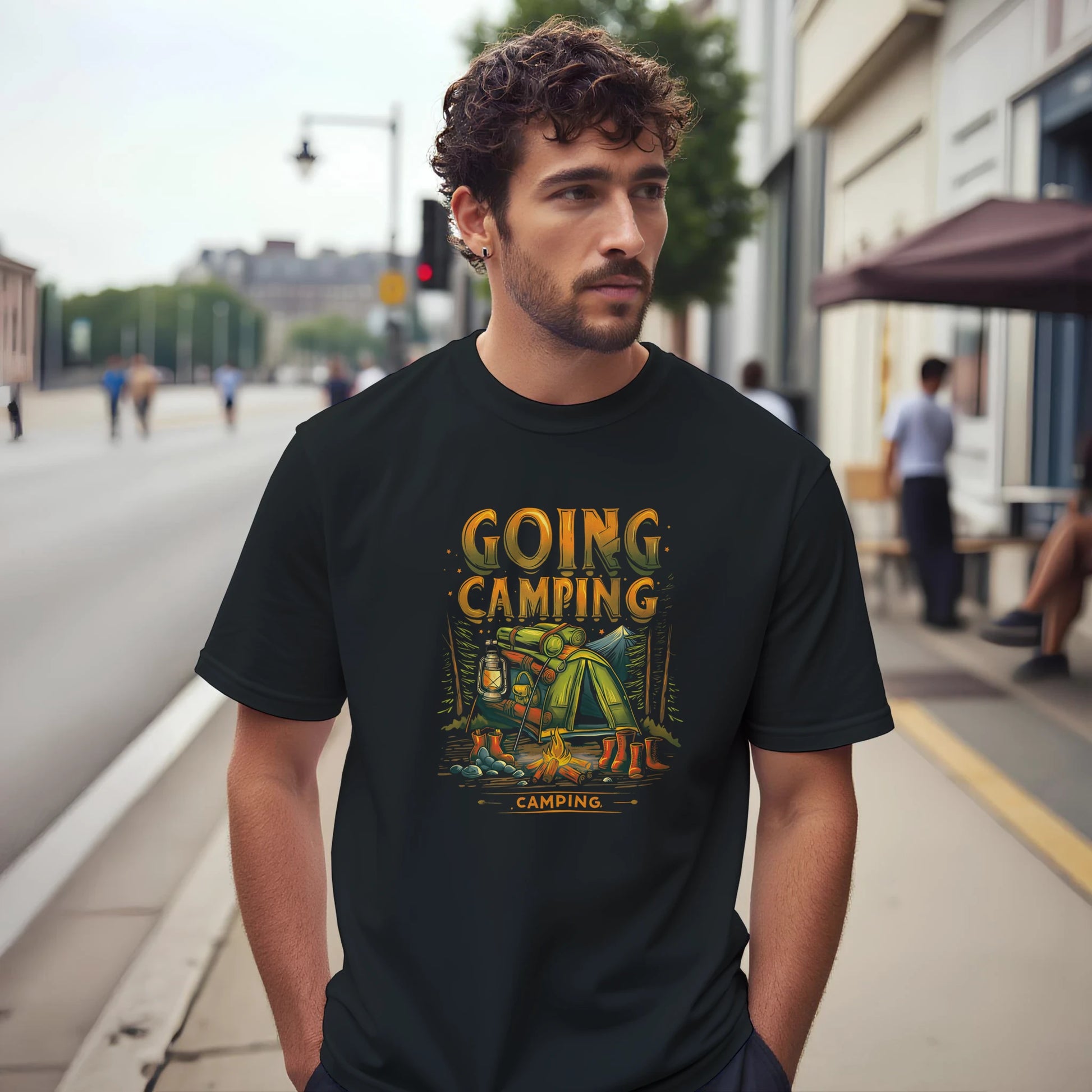 Man wearing a black t-shirt with 'Going Camping' graphic on a city street.