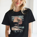 Close-up detail of distressed palm tree and sunset illustration – soft cotton fabric worn by a young girl