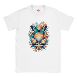 A white short-sleeve crewneck t-shirt featuring a colorful graphic print of an ocean shell and butterfly arrangement on the chest. The graphic includes a blue and black butterfly, a striped orange and beige seashell, a beige starfish, and teal and orange coral details.