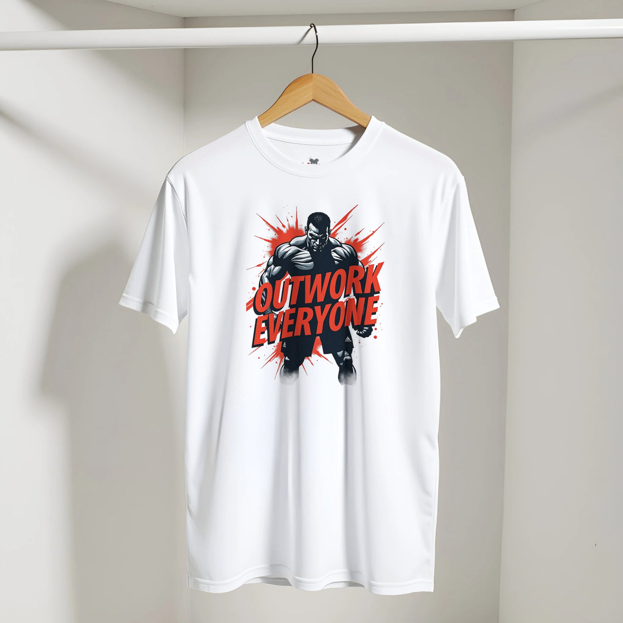 White t-shirt with 'Outwork Everyone' graphic on a hanger against a white wall.