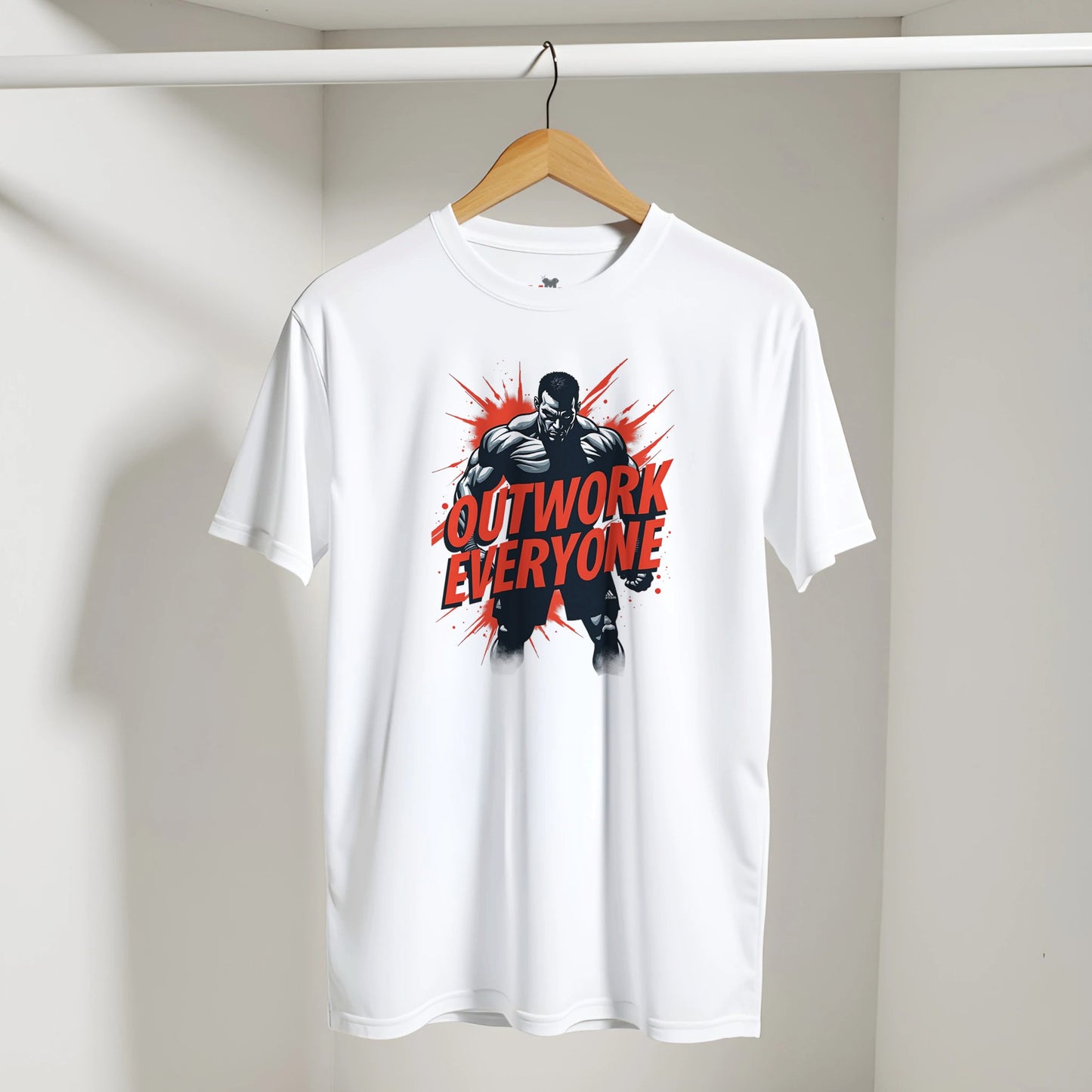 White t-shirt with 'Outwork Everyone' graphic on a hanger against a white wall.
