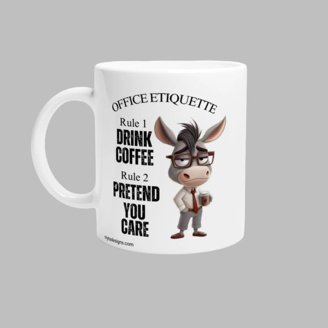 A white ceramic coffee mug with a glossy finish, featuring a humorous donkey character in glasses and a black shirt, surrounded by text that reads 'Office Etiquette', 'Drink Coffee', and 'You Care'. The mug is designed with a vivid print that maintains its quality over time.