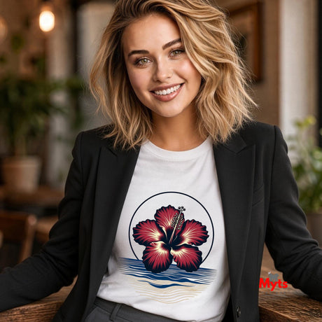 A sophisticated woman wearing a White tropical hibiscus flower graphic T-shirt featuring a vibrant red bloom, navy circular outline, and stylised blue and sandy-gold ocean waves.