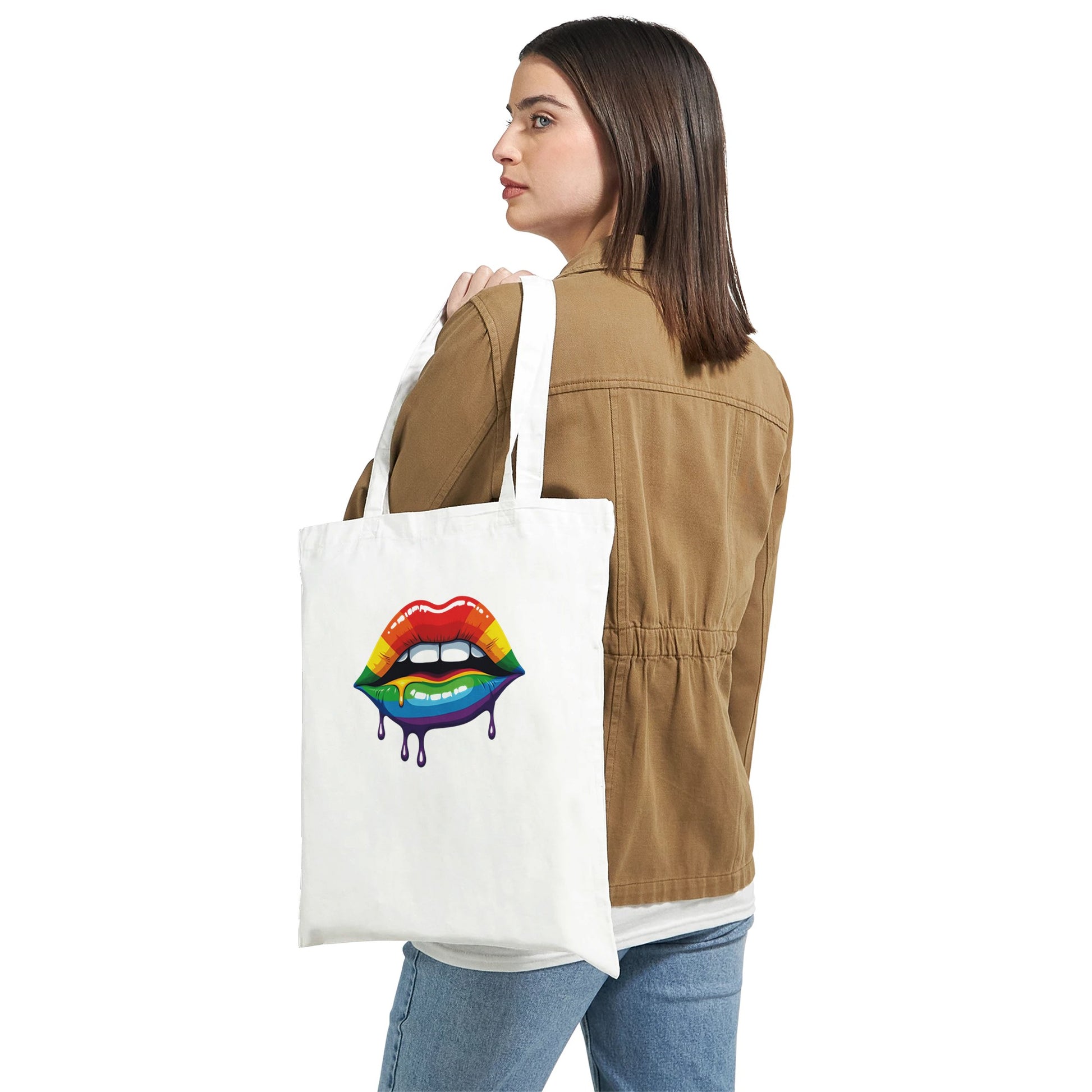 Woman holding a tote bag with a colorful lip design on a white background